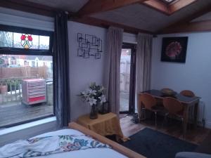 a bedroom with a bed and a table with a vase of flowers at Divis street guest house in Belfast