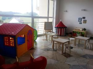 a play room with tables and a play house at ALMET štúdio 404 in Donovaly