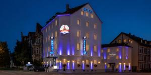a building with blue lights on the side of it at HOTEL ATLANTA Darmstadt SUPERIOR in Darmstadt