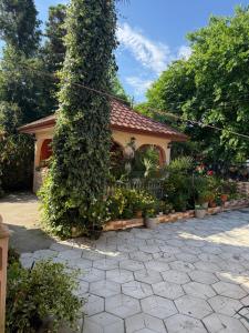 a house with a large tree in front of it at Guest House Gio in Gonio +28 photos