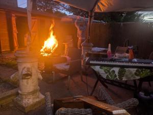 a fire in a yard with a table and a piano at Bramcote House in Bramcote