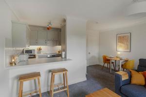 a kitchen and living room with a couch and a table at 1 Bed in Windermere oc-lr189 in Windermere