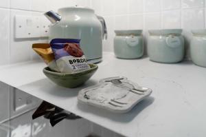 a counter with a bowl of food and a tea pot at 1 Bed in Windermere oc-lr189 in Windermere +12 photos