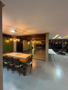 a large dining room with a table and chairs at Casa Pé no Sal in Salinópolis