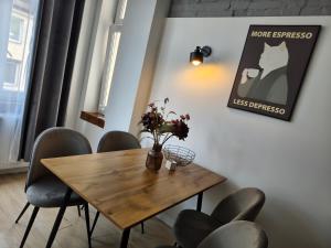 a dining room with a wooden table and chairs at 1904 Studio in Świnoujście