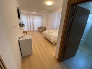 a bedroom with a bed and a couch in a room at Venecia gold in Struga