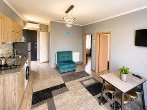 a kitchen and living room with a table and a chair at Apollo Plus Cottages in Ureki