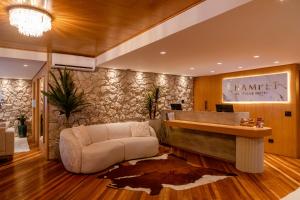 a lobby with a reception desk and a couch at Champet Boutique Hotel in Campos do Jordão +90 photos