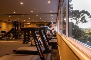 a gym with a treadmill and a window at Champet Boutique Hotel in Campos do Jordão
