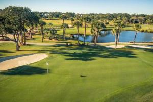 an overhead view of a golf course with a lake at 1315 Pelican Watch Villas-Beachfront & Amenities - on Sale in Seabrook Island