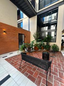 a courtyard with a bench and plants in a building at Tradere in Guadalajara