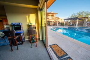 a view of a swimming pool with two chairs and a mirror at Sorelle Vineyard in Cornville