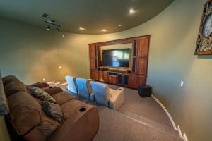 a living room with a couch and a flat screen tv at Sorelle Vineyard in Cornville