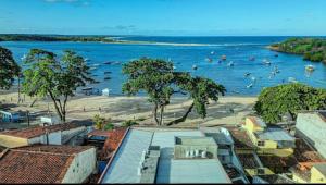 a beach with a bunch of people in the water at Cairé Suites in Itacaré