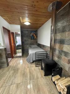 a bedroom with a bed and a fireplace in a room at Hospedaje Shuyen in Victoria