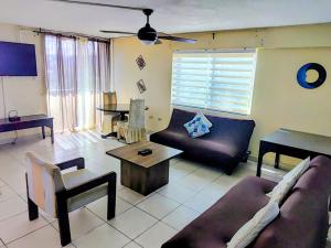 a living room with a couch and a table at Beach-side condos at Turtle Beach Towers in Ocho Rios