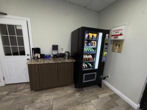 a black refrigerator in a room with a counter at Falls Lodge by the Falls (Formerly Knights Inn) in Niagara Falls