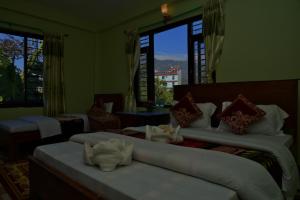 Una cama o camas en una habitación de Hotel Mandala