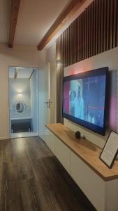 a living room with a flat screen tv on a wall at Apartment Oaza in Mostar