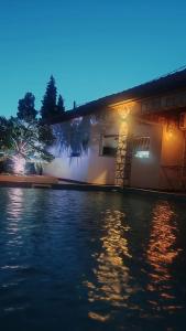 a house with a swimming pool at night at Apartment Oaza in Mostar