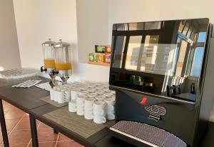 a counter with a coffee machine in a room at Residencial do Vale in Funchal
