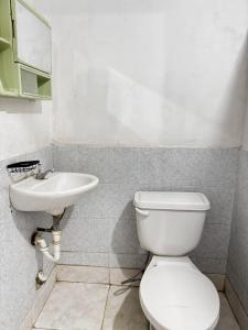 a bathroom with a toilet and a sink at Cary's Studio in David +5 photos