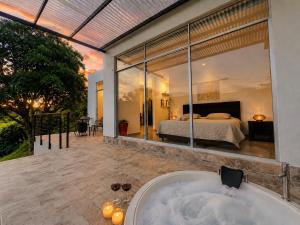 a bath tub in the middle of a bedroom with a bed at Finca Samana in Tocaima