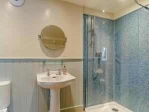 a bathroom with a sink and a glass shower at 6 Bed in Norwich oc-42594 in Shelton +35 photos