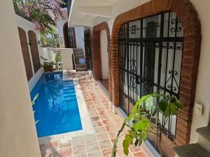 a swimming pool in a house with an iron gate at Casa Rey Sol Vallarta in Puerto Vallarta