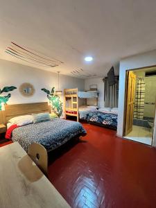 a bedroom with two beds and a mirror at Kinti Wasi Casa de Campo Hospedaje in Los Baños del Inca