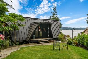 a metal building with a table and chairs in a yard at The Loft | Beach | Kayaks & Pickleball in Bremerton