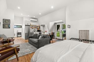 a bedroom with a bed and a living room at The Loft | Beach | Kayaks & Pickleball in Bremerton