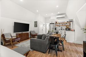 a living room with a couch and a table at The Loft | Beach | Kayaks & Pickleball in Bremerton +23 photos