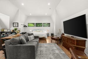 a living room with a couch and a flat screen tv at The Loft | Beach | Kayaks & Pickleball in Bremerton