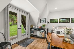 a bedroom with a bed and a dining room with a table at The Loft | Beach | Kayaks & Pickleball in Bremerton