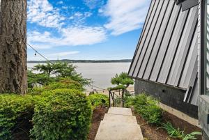 a walkway leading to a house with a view of the water at The Waterwheel in Bremerton