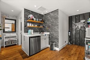 a kitchen with a white counter and a gray wall at The Waterwheel in Bremerton +24 photos