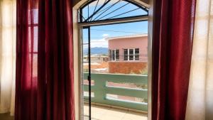 an open window with a view of a building at Suite Familiar Afrodita - Centro Histórico in Comayagua +12 photos