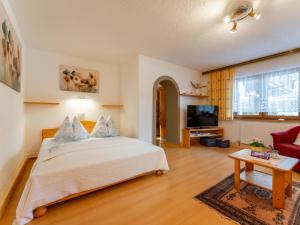 a bedroom with a bed and a living room at Maria in Leogang