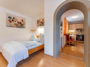 a bedroom with a bed in a room with a kitchen at Maria in Leogang