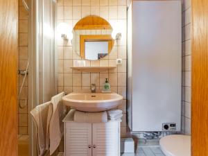 a small bathroom with a sink and a mirror at Maria in Leogang +20 photos