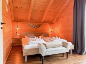 a bedroom with two beds in a wooden room at Rattendorf 5B in Rattendorf