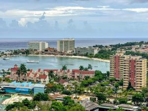 a view of a city with a beach and buildings at Beach-side condos at Turtle Beach Towers in Ocho Rios