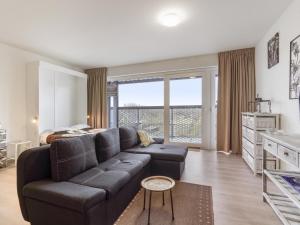 a living room with a couch and a bed at B City Complex - 0209 in Blankenberge