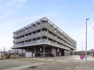 a large building in a parking lot at B City Complex - 0209 in Blankenberge