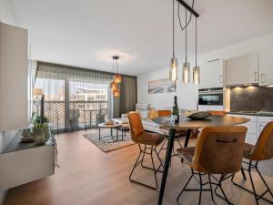 a kitchen and dining room with a table and chairs at B City Complex - 0302 in Blankenberge