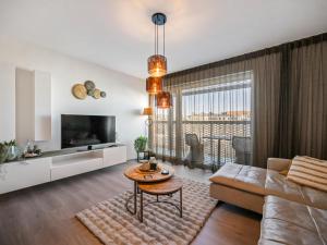 a living room with a couch and a table at B City Complex - 0302 in Blankenberge