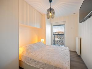 a bedroom with a bed and a window at B City Complex - 0302 in Blankenberge