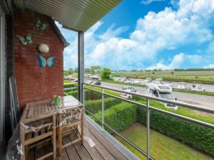 a balcony with a table and butterflies on a highway at Nieuwendamme 40C in Lombardsijde