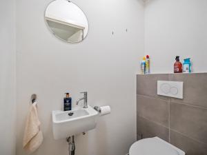 a bathroom with a white toilet and a mirror at B City Complex - 0302 in Blankenberge +9 photos
